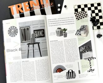 Beitrag im Fachmagazin Trend and Style Ausgabe 3/2025, mit aufgeschlagenem Artikel sichtbar und einen kleinen Schachbrett daneben als Dekoration