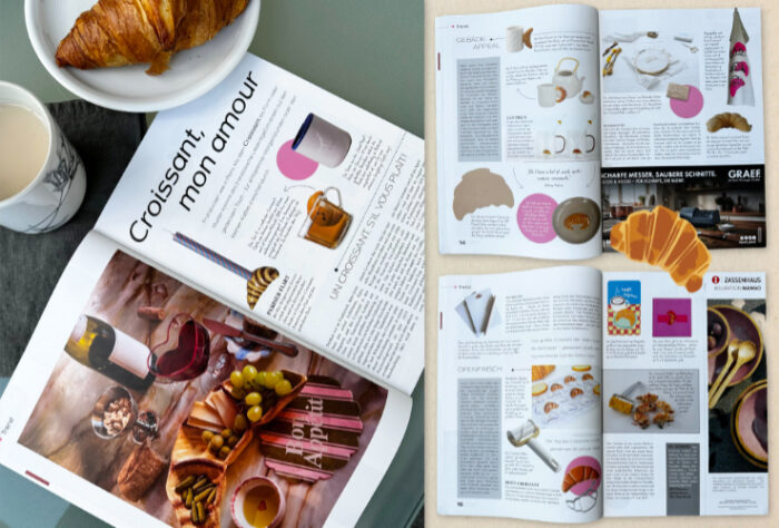 zu sehen ist das aufgeschlagene Magazin mit den 3 Doppelseiten des Artikels sowie ein Croissant auf einem Teller